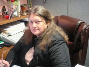 A woman sitting at her desk in the office.